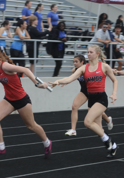 RUNNING FOR GLORY:  Freshman Ellie Grigsby finishes an important hand-off to keep Bowie’s chances of winning alive. Grigsby had a very successful first track season as a bulldog.